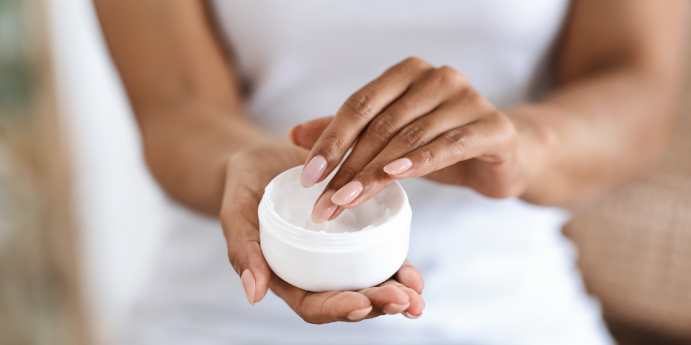 Woman holding jar of cream