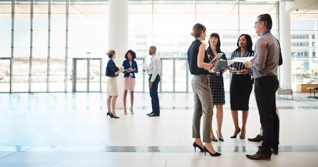 People standing at a conference talking