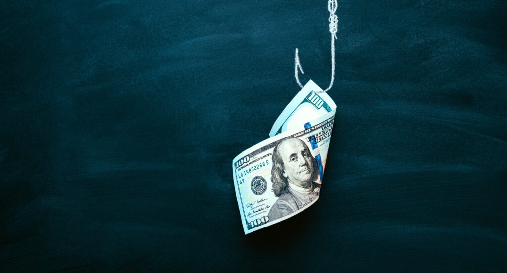 A picture of a large bill hanging from a hook with a dark background.