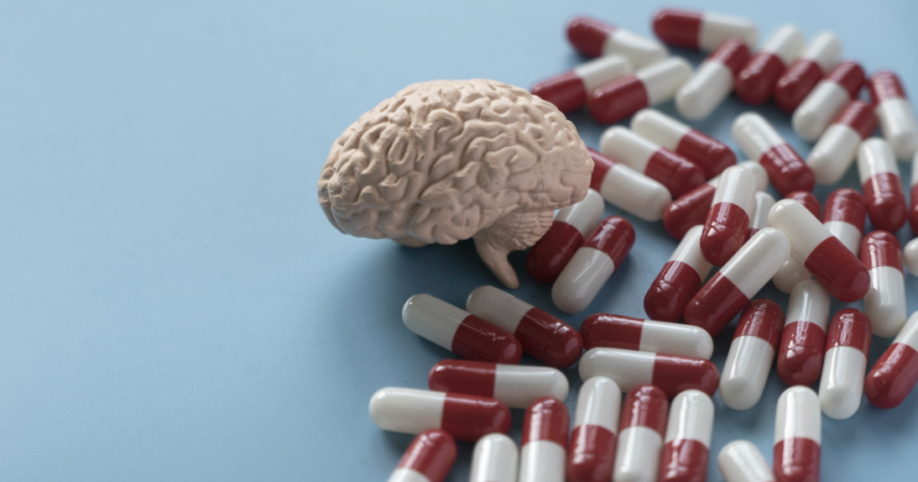 Nootropics blog post image of brain and pills on blue background.