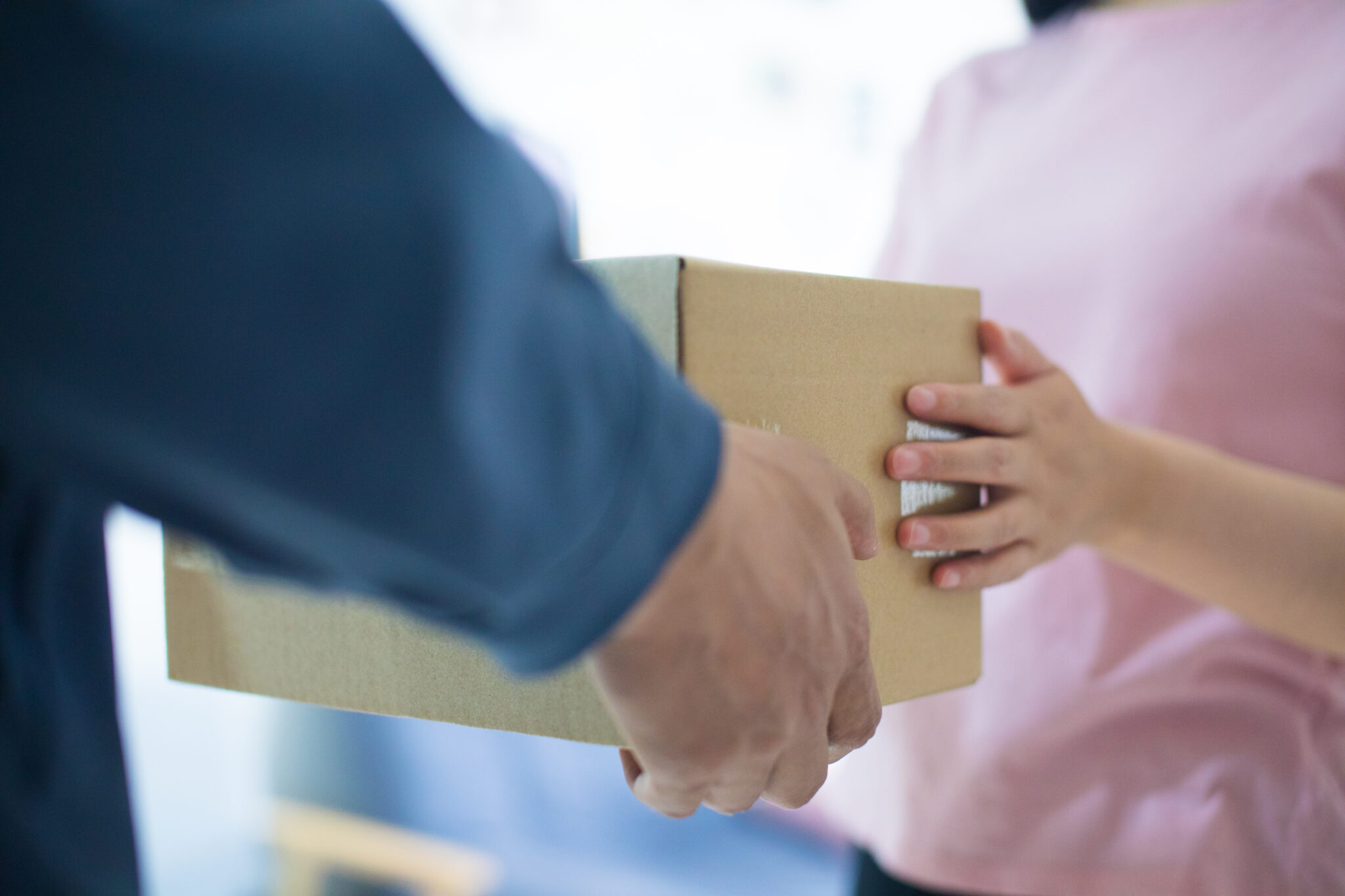 Woman hand accepting a delivery of boxes