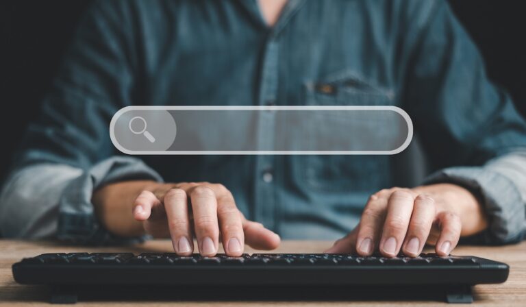 Search technology Search Engine Optimization With a blank search bar. Interesting things on the internet, a man's hand typing on a keyboard.