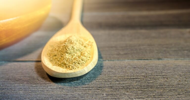 Spoon with Kava Kava root powder in wooden cup