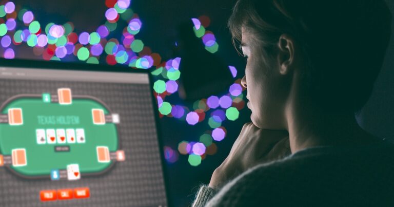 Woman playing online poker late at night, games and gambling concept