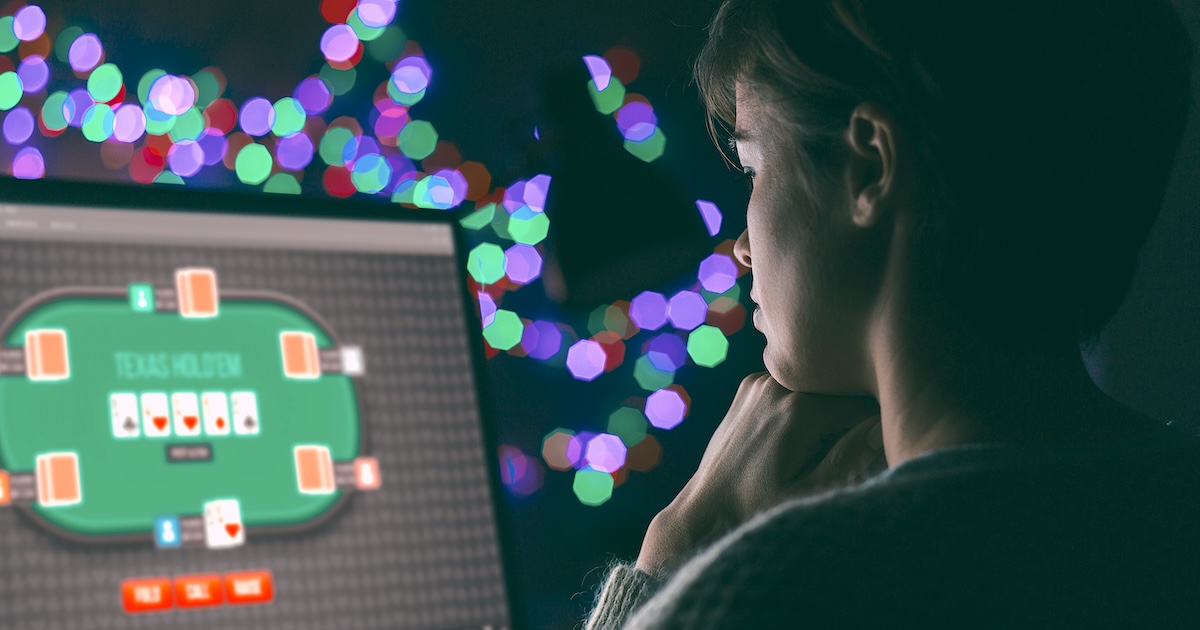 Woman playing online poker Woman playing online poker late at night, games and gambling concept