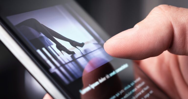 Man watching erotic video or looking at sexy photo with phone. Sex shop or online porn website. Person reading news article about sexual topic. Escort business, strip show or adult content on internet