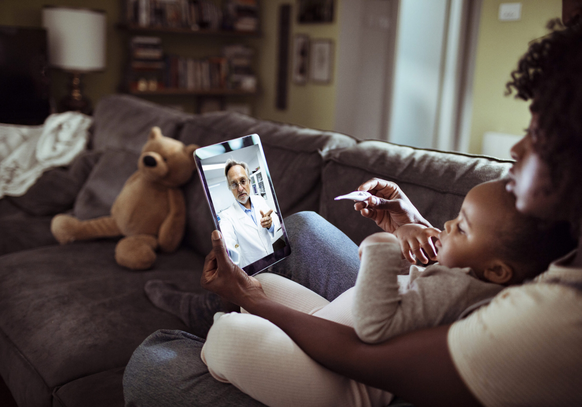 Online Consultation with their Doctor Close up of a mother and daughter consulting with their doctor over a video call on their digital tablet