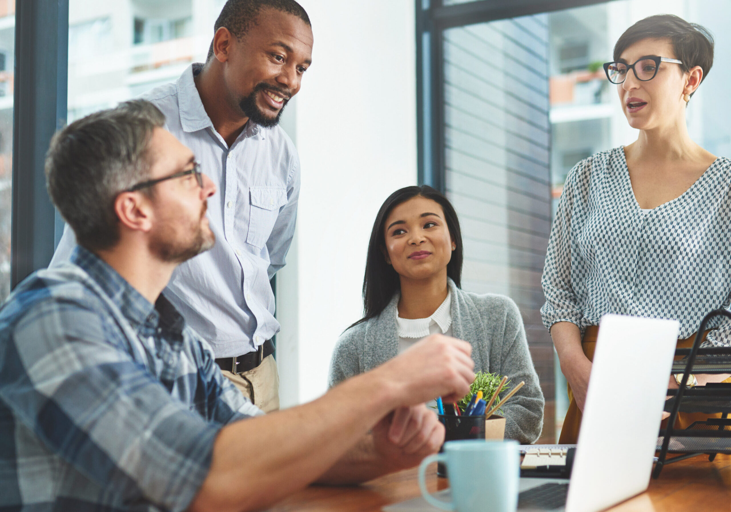The most successful ideas are formulated as a team Cropped shot of a group of colleagues working together on a laptop in a modern office