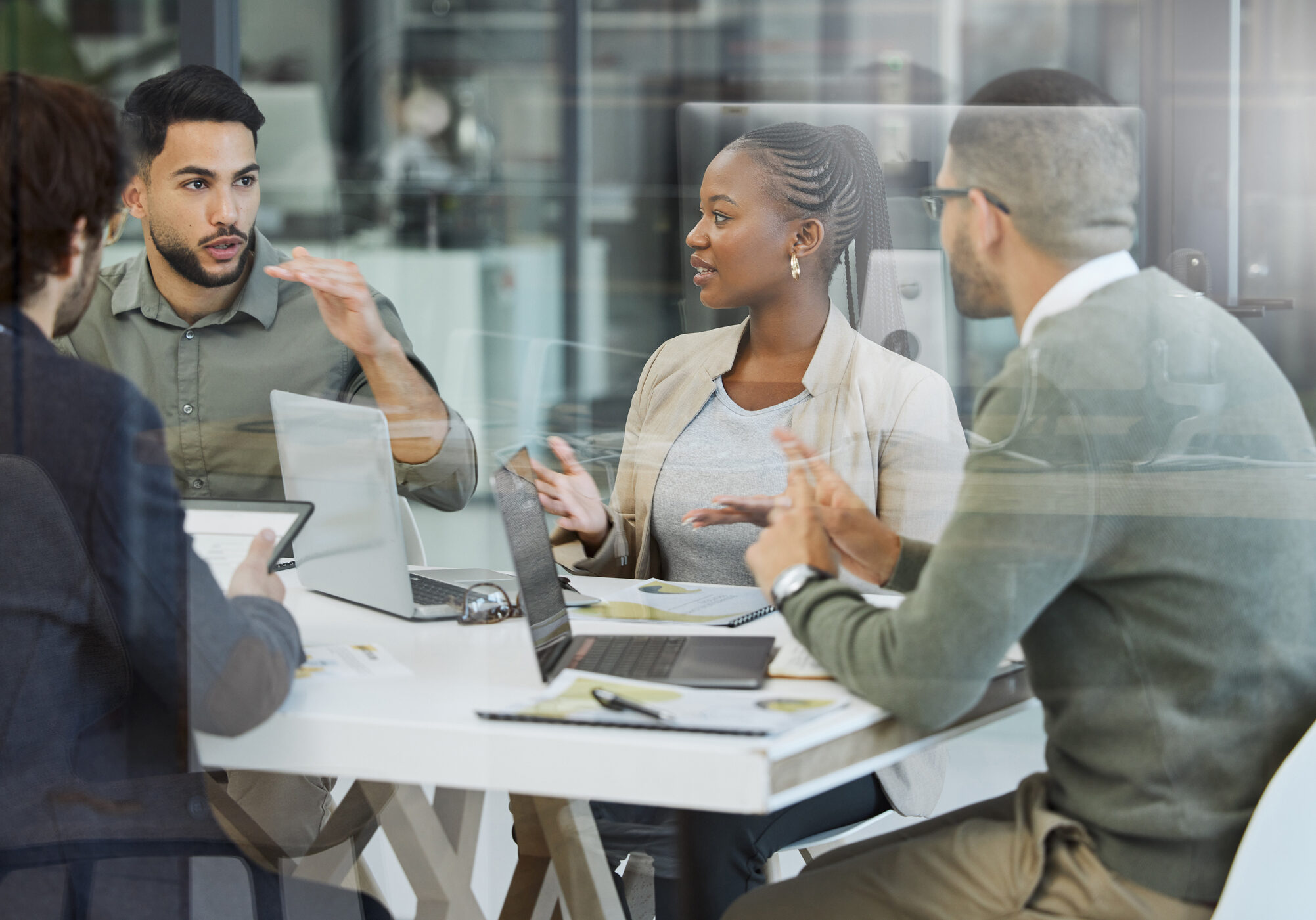 Shot of a group of businesspeople having a meeting in an office at work Let's talk about it