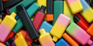 Close-up of a stack of colorful  electronic vaporizer or e-vaporizer aka electronic cigarettes or collection of vapes.